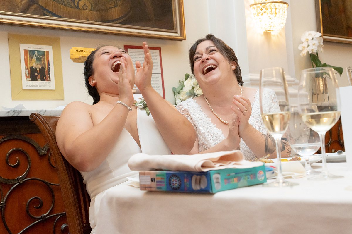 Zwei Bräute lachen beim Dinner
